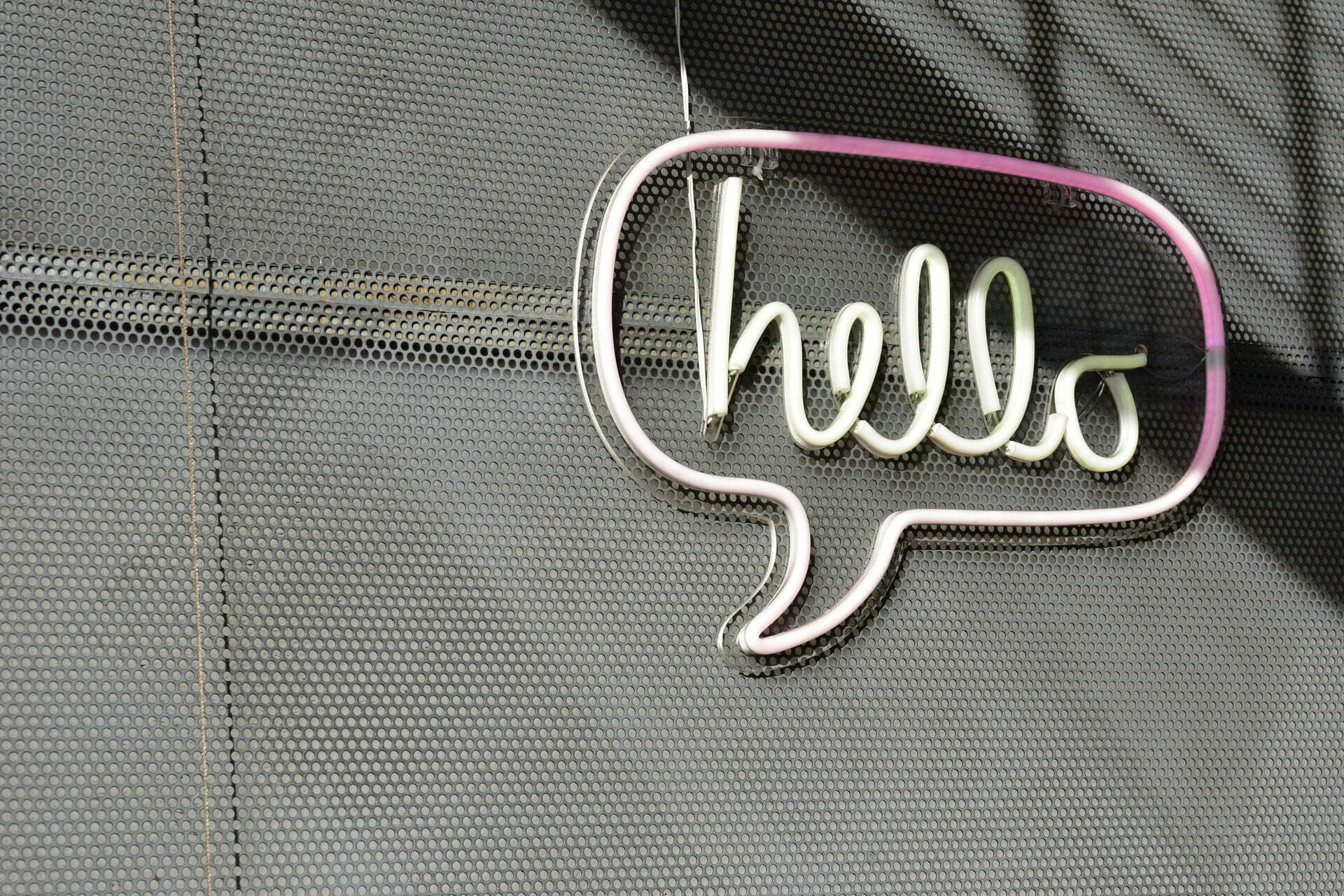 a white logo on a grey surface